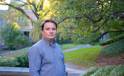 A man in a blue shirt in a garden